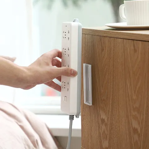 Suporte de parede punch-livre plug fixador auto-adesivo soquete fixador cabo tira de energia titular cabo fio organizador rack